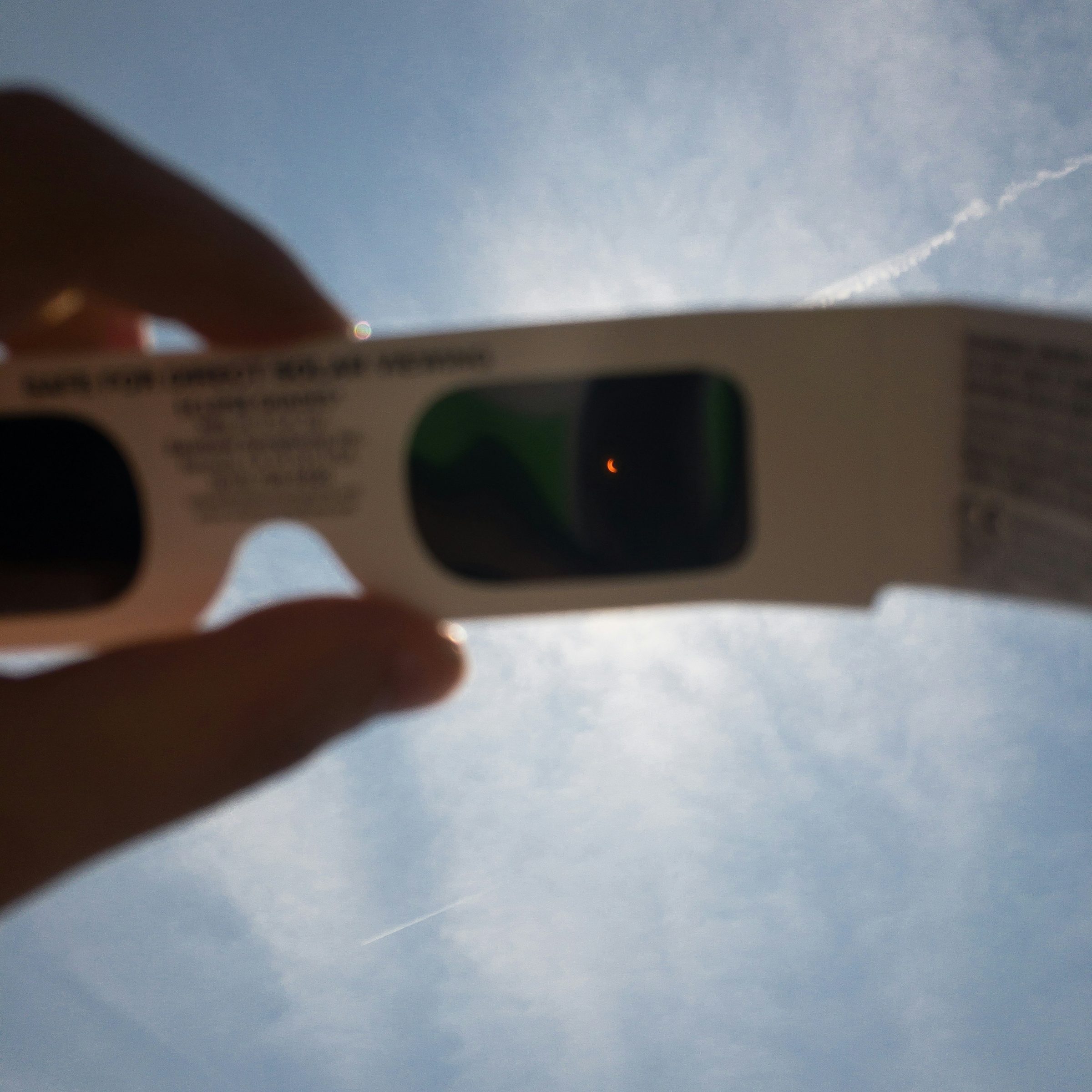People wearing eclipse glasses for safe solar eclipse viewing