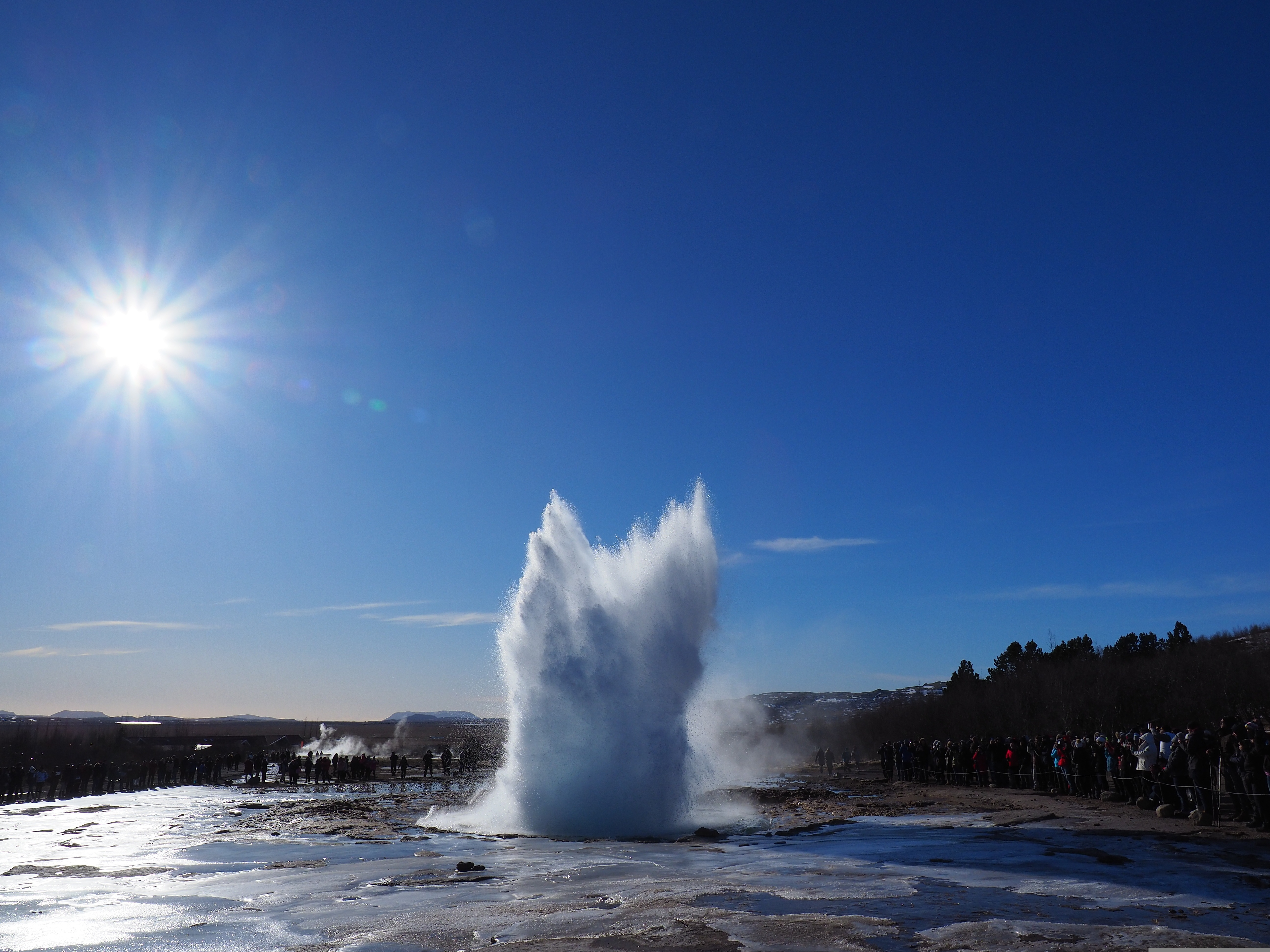 Strokkur geyser erupting in a column of water and steam at the Geysir geothermal area