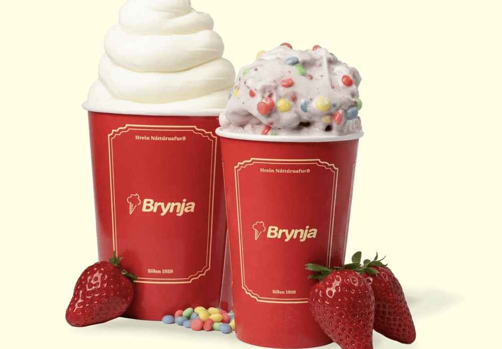 Two Brynja cups — one with a tall soft-serve swirl, one with a bragðarefur full of candy