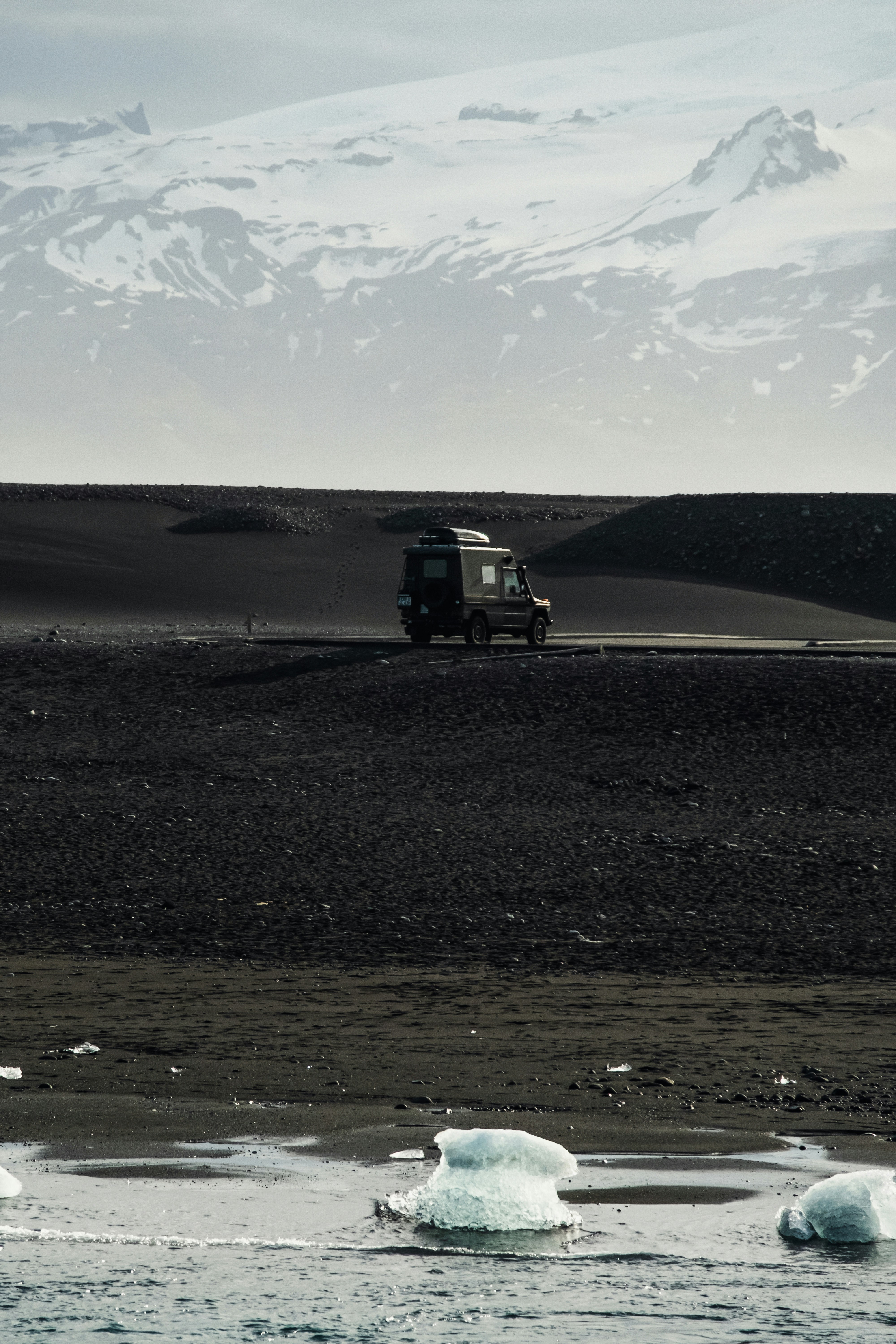 4x4 vehicle on black sand beach in Iceland