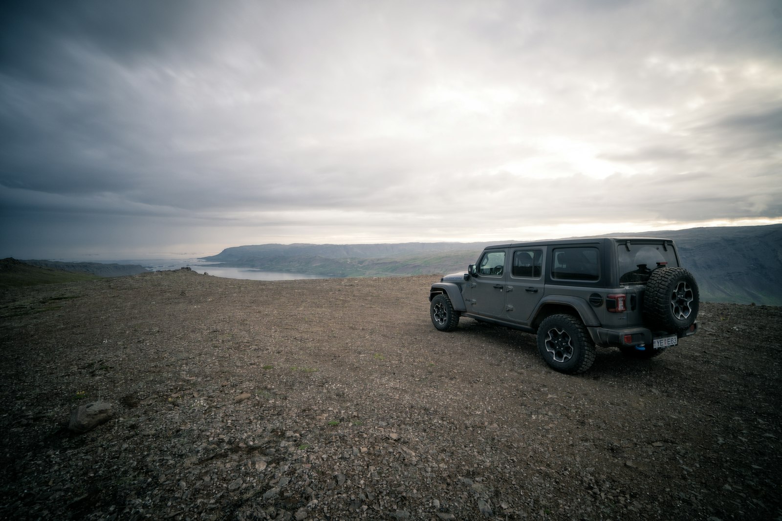 Rental car parked beside an Icelandic road viewpoint