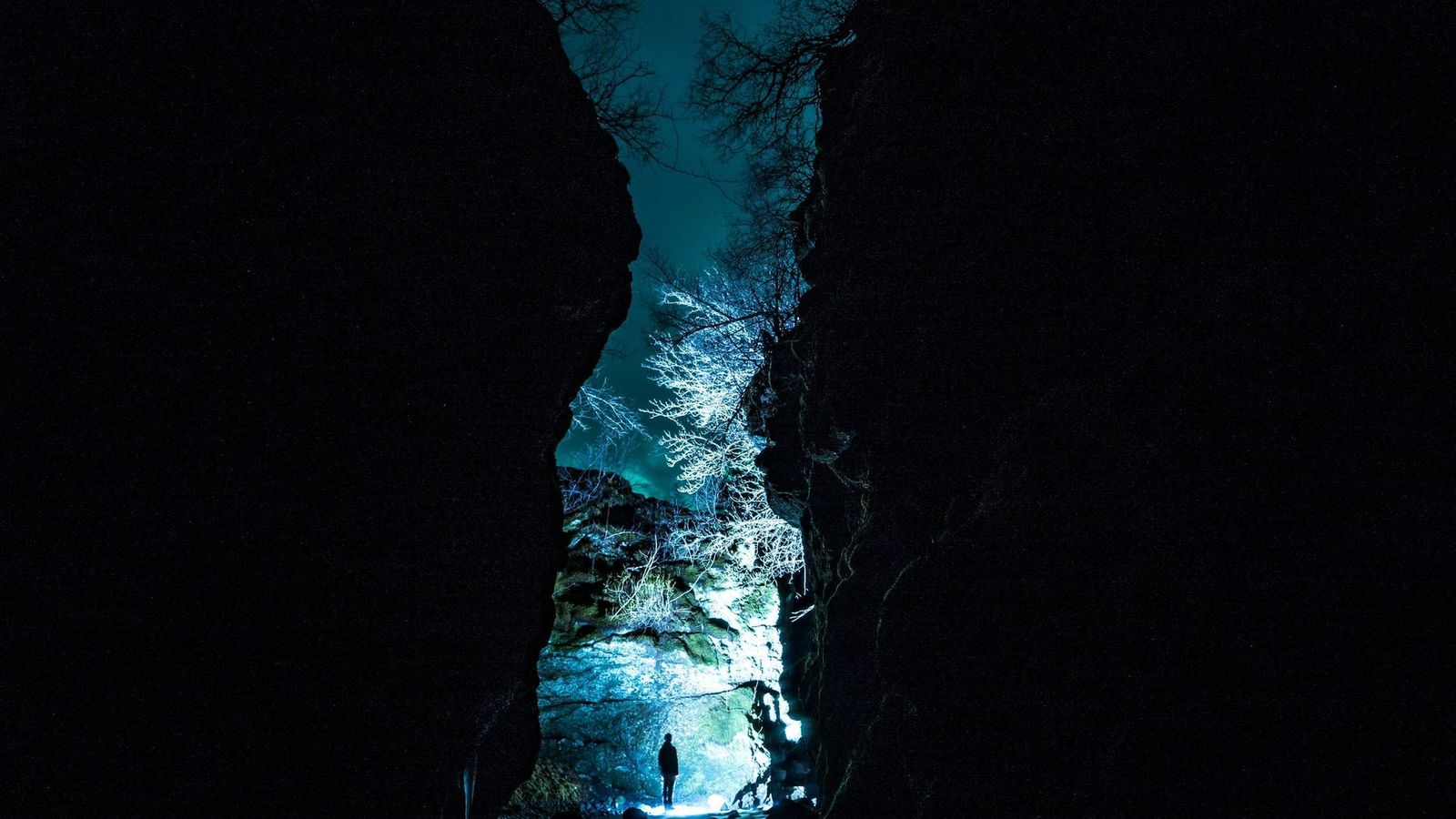 Deep blue ice walls inside a natural glacier ice cave in Iceland