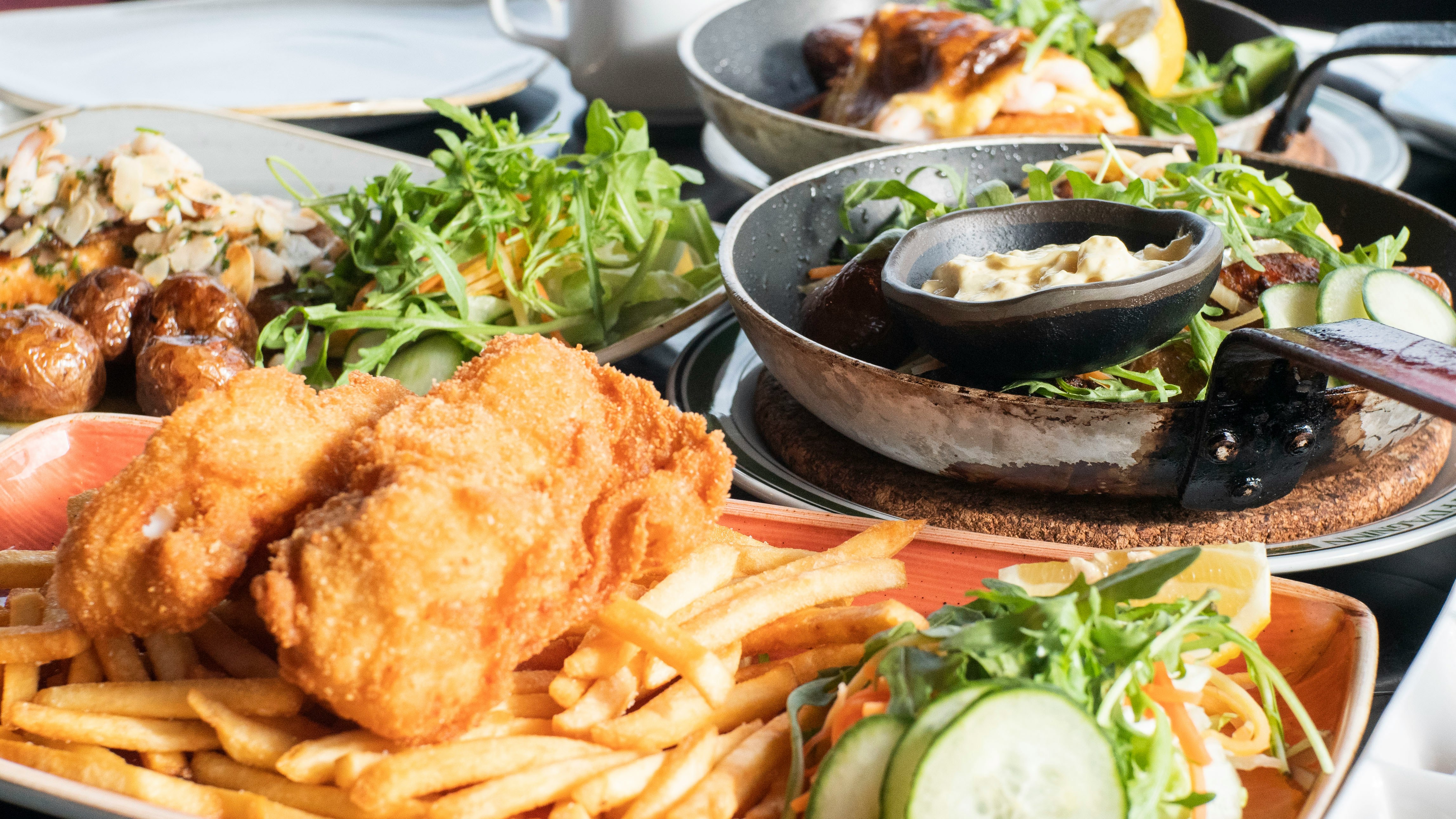 A table of Icelandic food dishes served with fresh vegetables