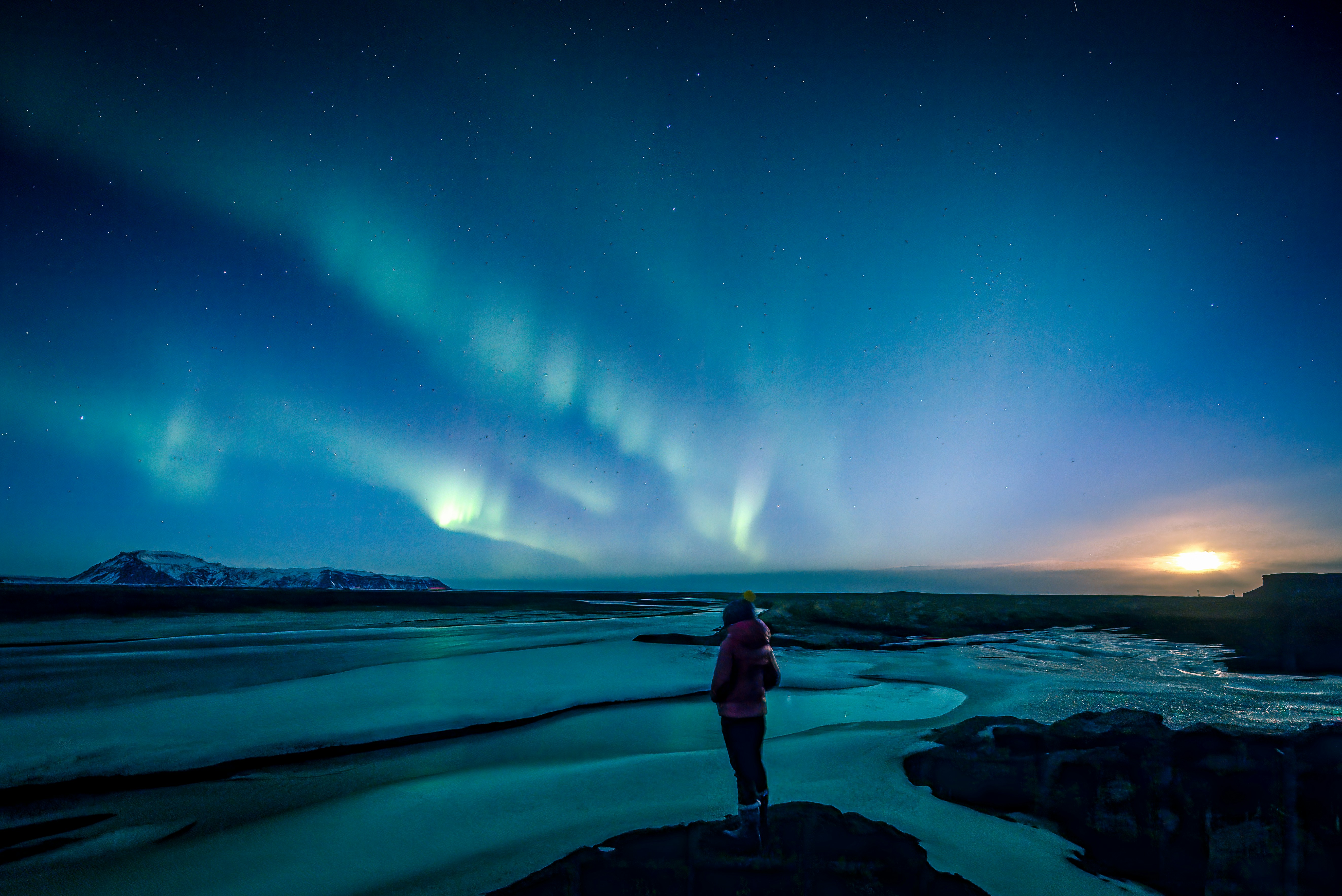 Northern lights reflected in an Icelandic river at night