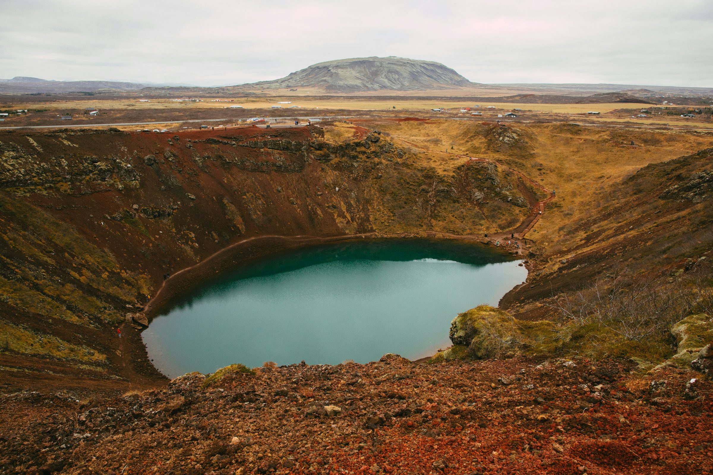 Kerið volcanic crater lake with red rim and turquoise water