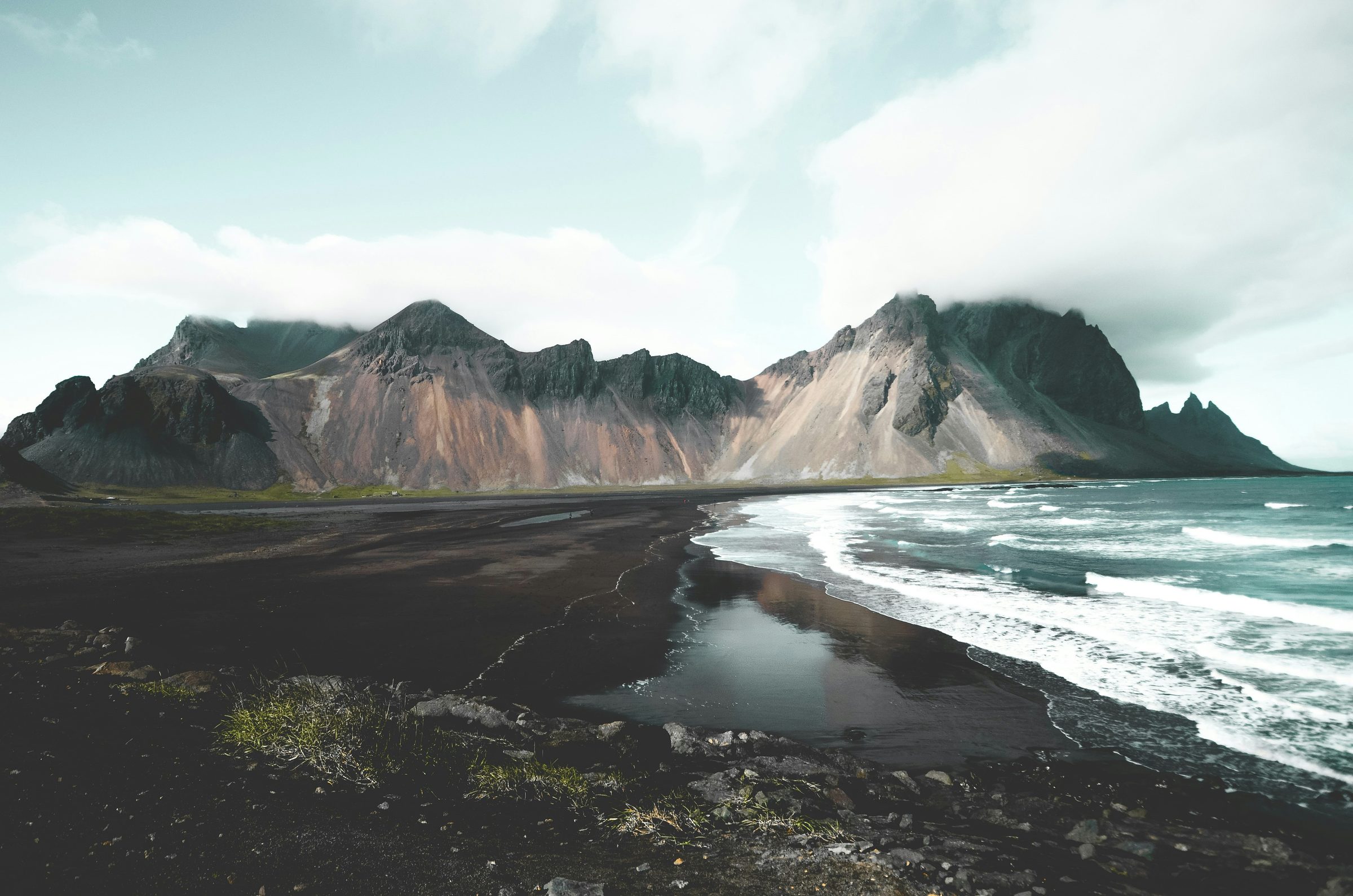 Vestrahorn mountain rising over a black sand peninsula in East Iceland