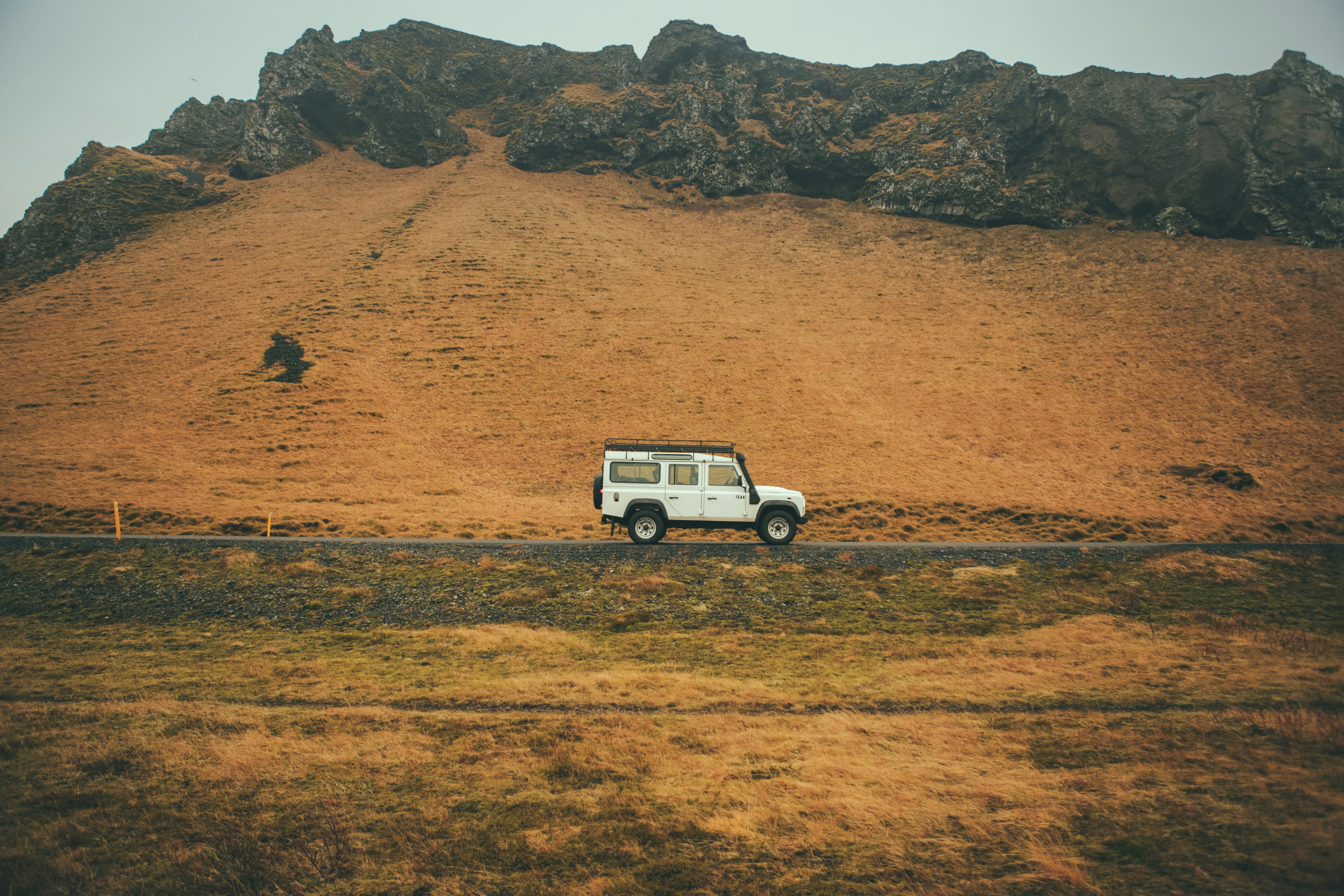 Small 4x4 driving on a gravel track through the Icelandic countryside