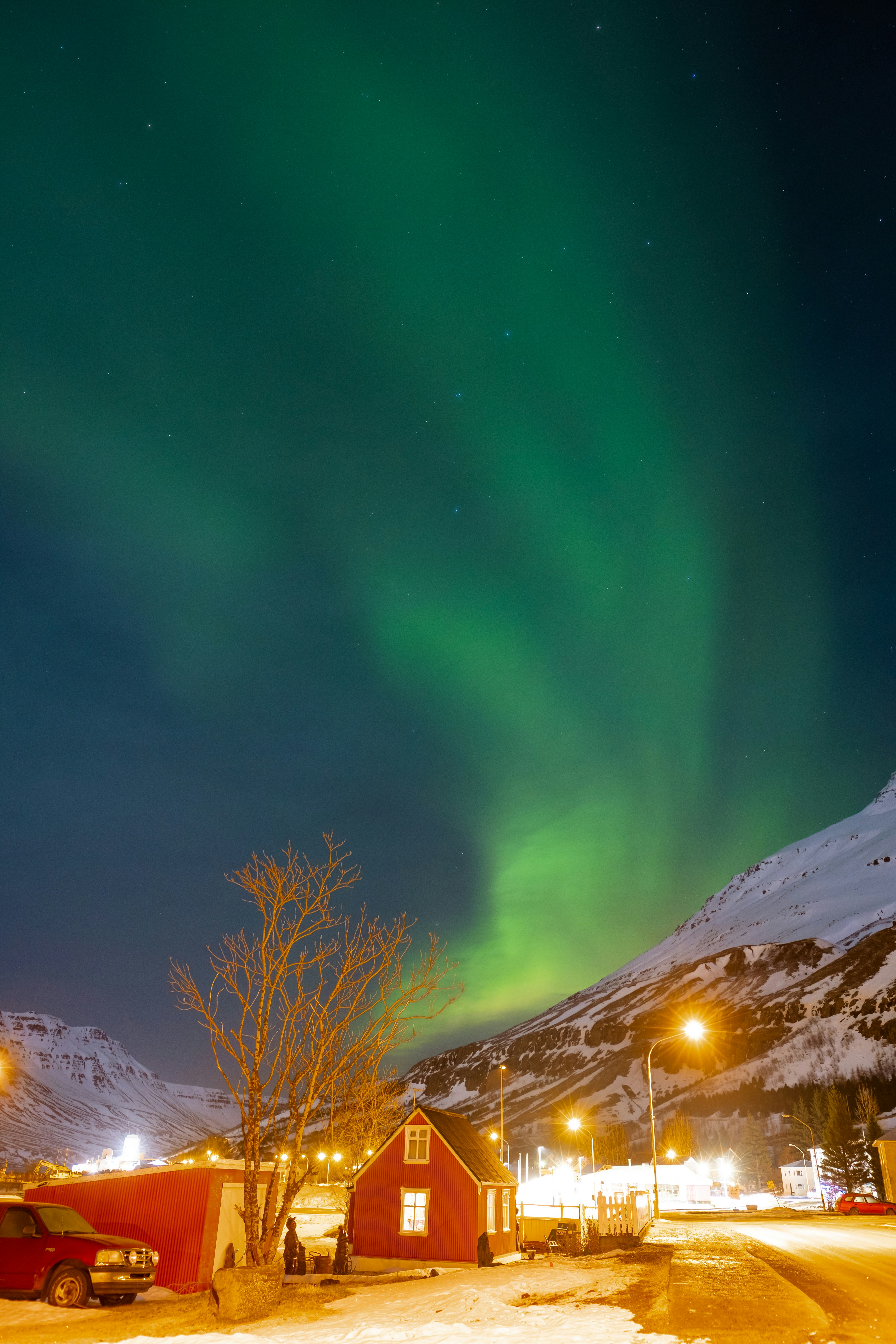 Northern lights over a small northern Iceland town at night